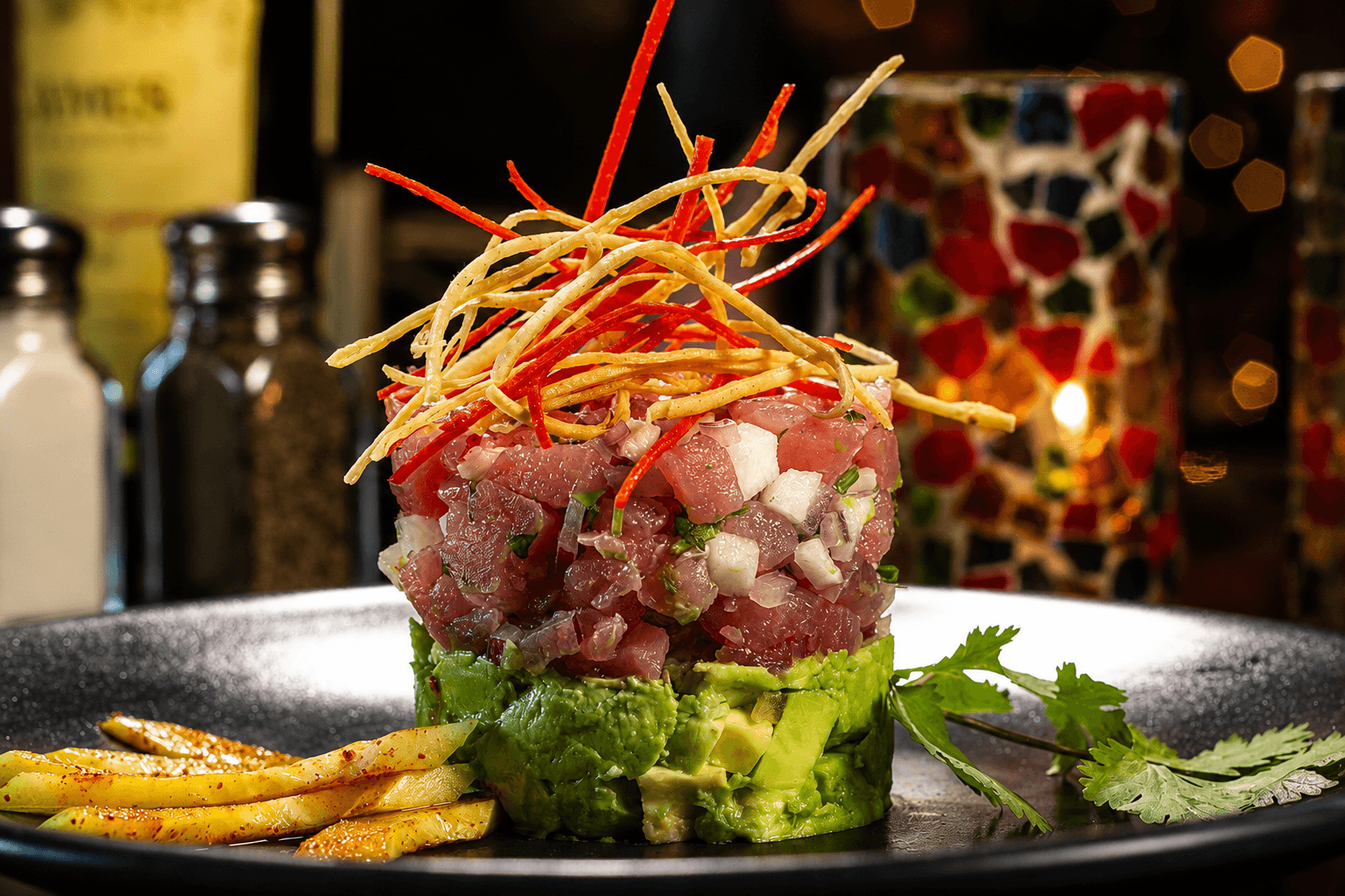 Ahi tuna ceviche tower with tortilla strings and mango