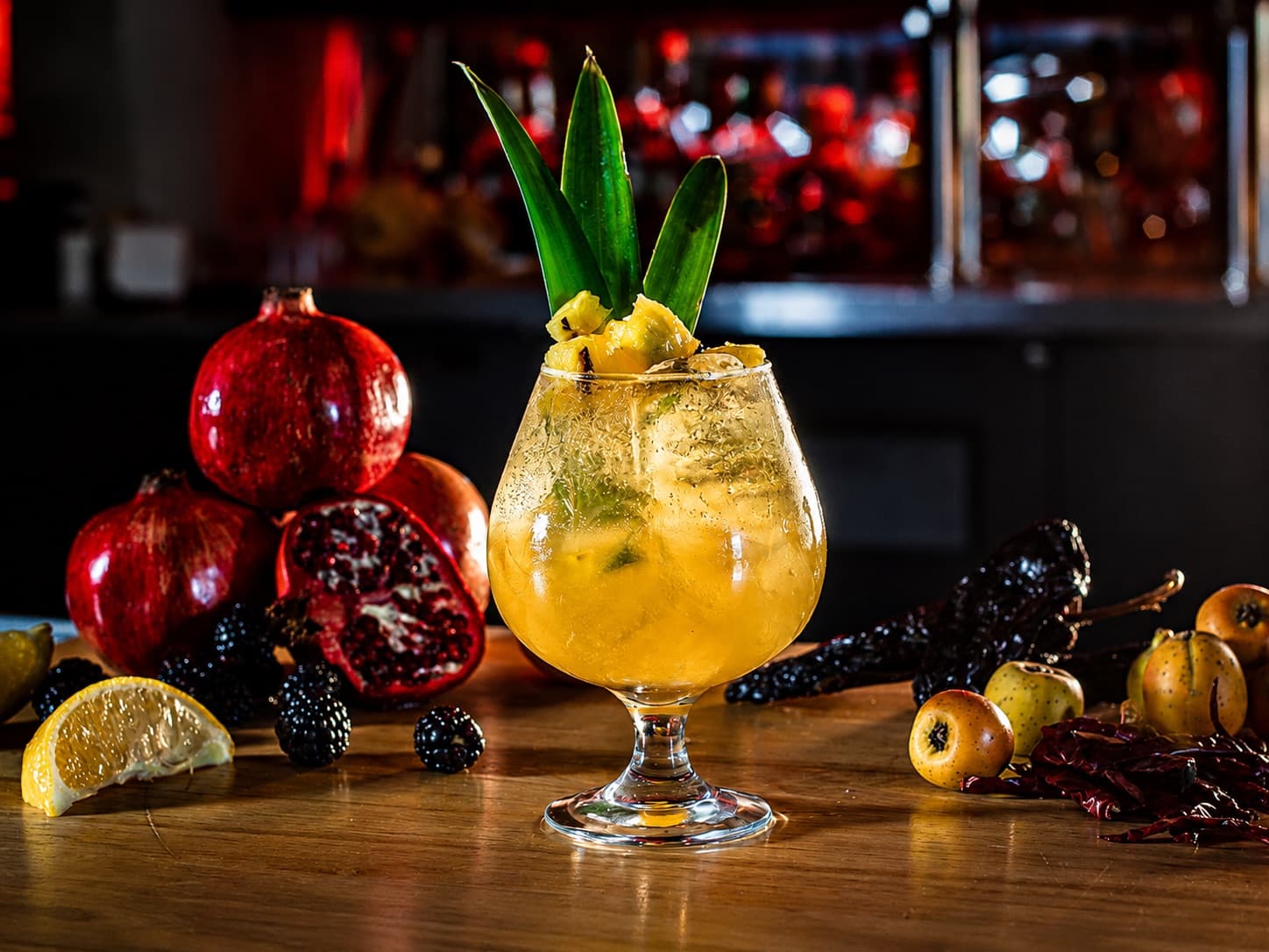 Tropical cantina cocktail with pineapple, pomegranate, and chile